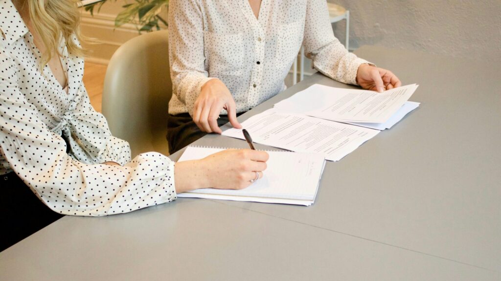 A woman lawyer helps a client with estate planning.