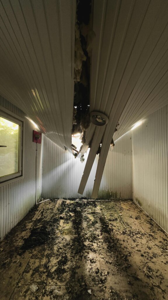 A room in a house with a collapsed ceiling.