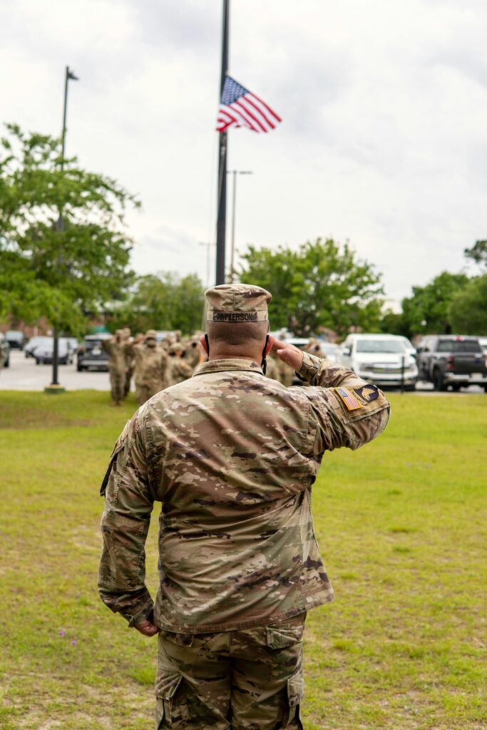 A US soldier salutes a flag at half-staff.