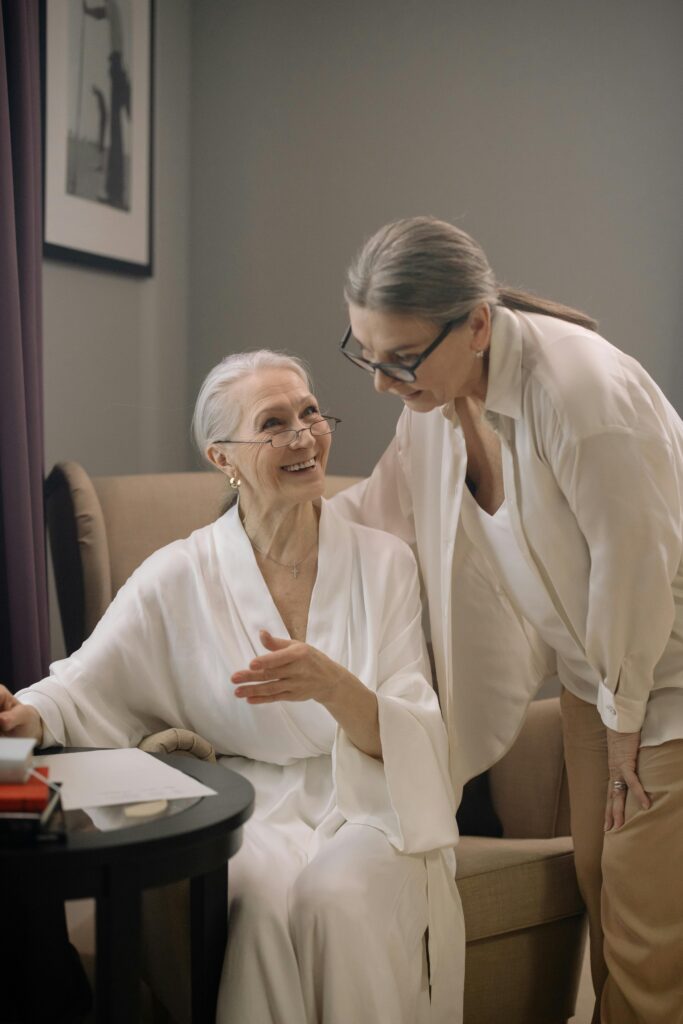 A woman helps her mother with paperwork.