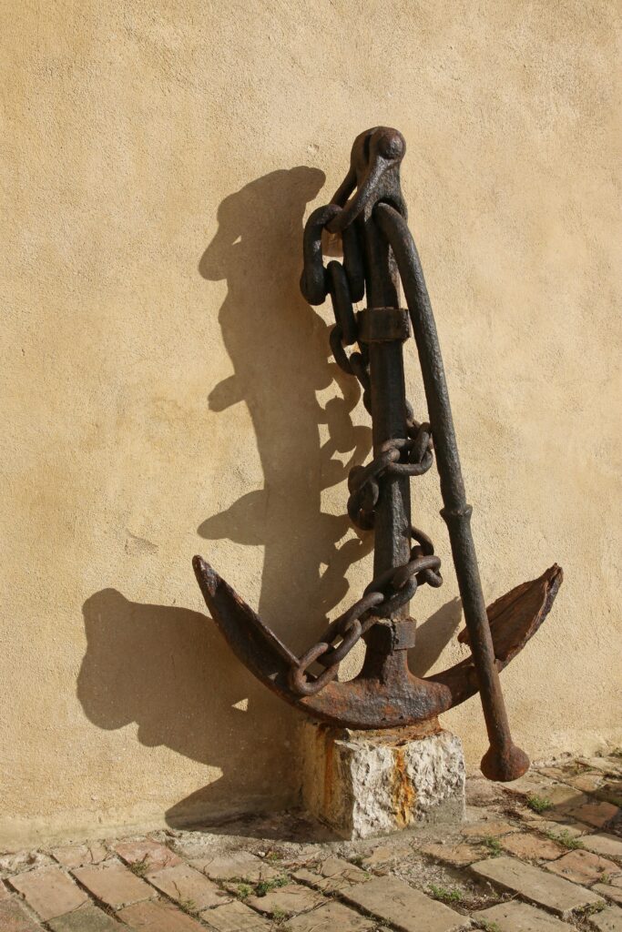 An anchor leaned against a wall.